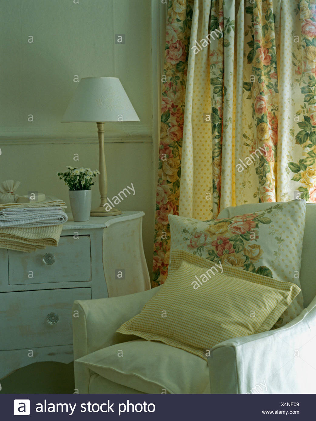 Bedroom With Yellow Checked And Rose Patterned Cushions On
