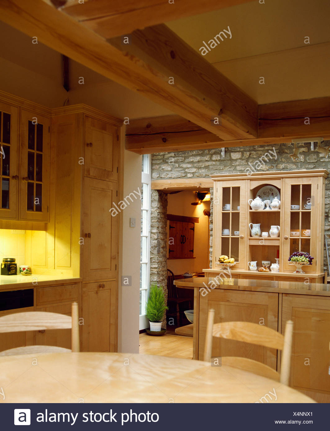 Beamed Ceiling In Country Kitchen With Pine Dresser On Stone Wall