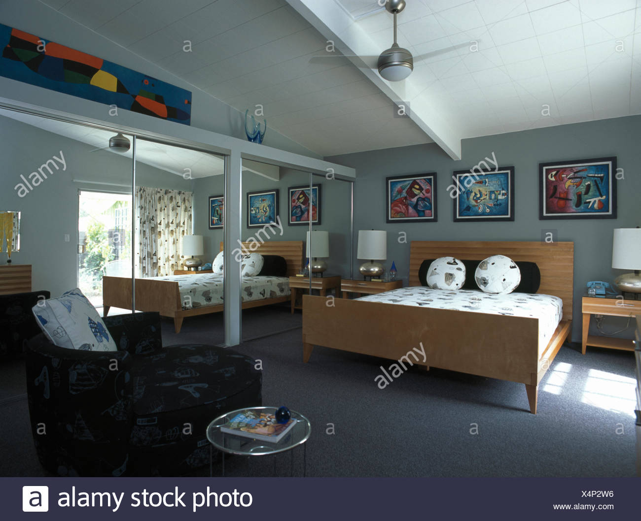 Mirrored Doors On Fitted Wardrobes In Modern Bedroom With Pale