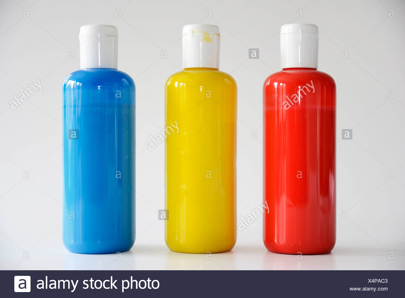 Download Red Yellow Blue Bottles On Gray Background Stock Photo Alamy PSD Mockup Templates