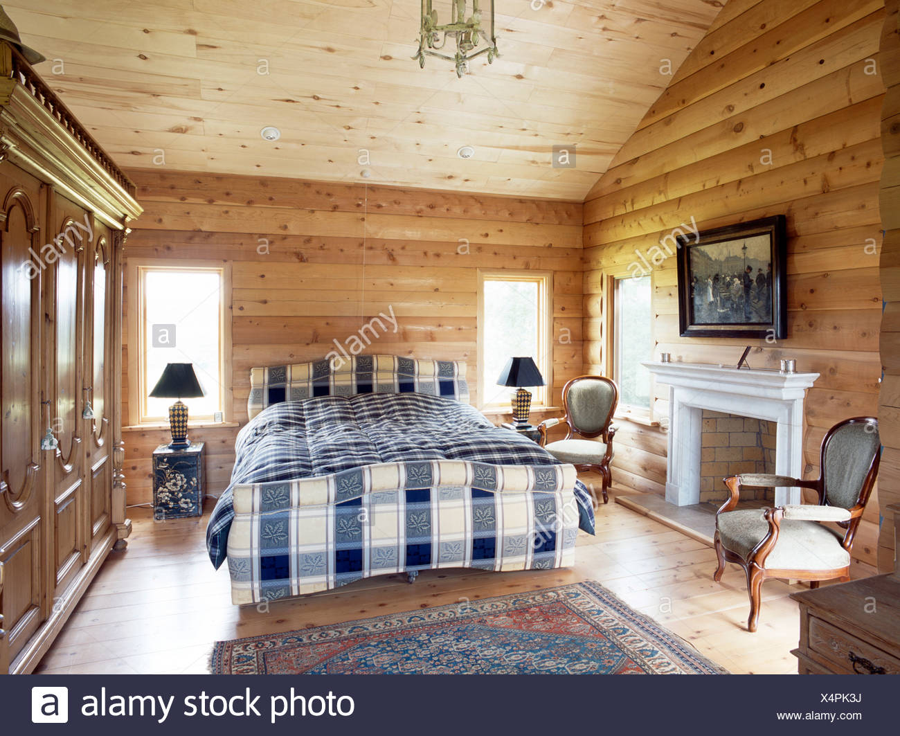 Blue White Bedlinen On Bed In Country Bedroom With Pine Log