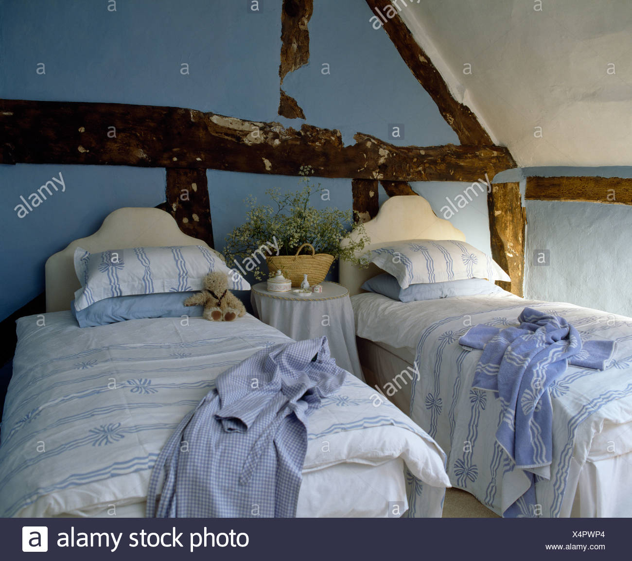 Pale Blue White Duvets And Matching Pillows On Twin Beds In