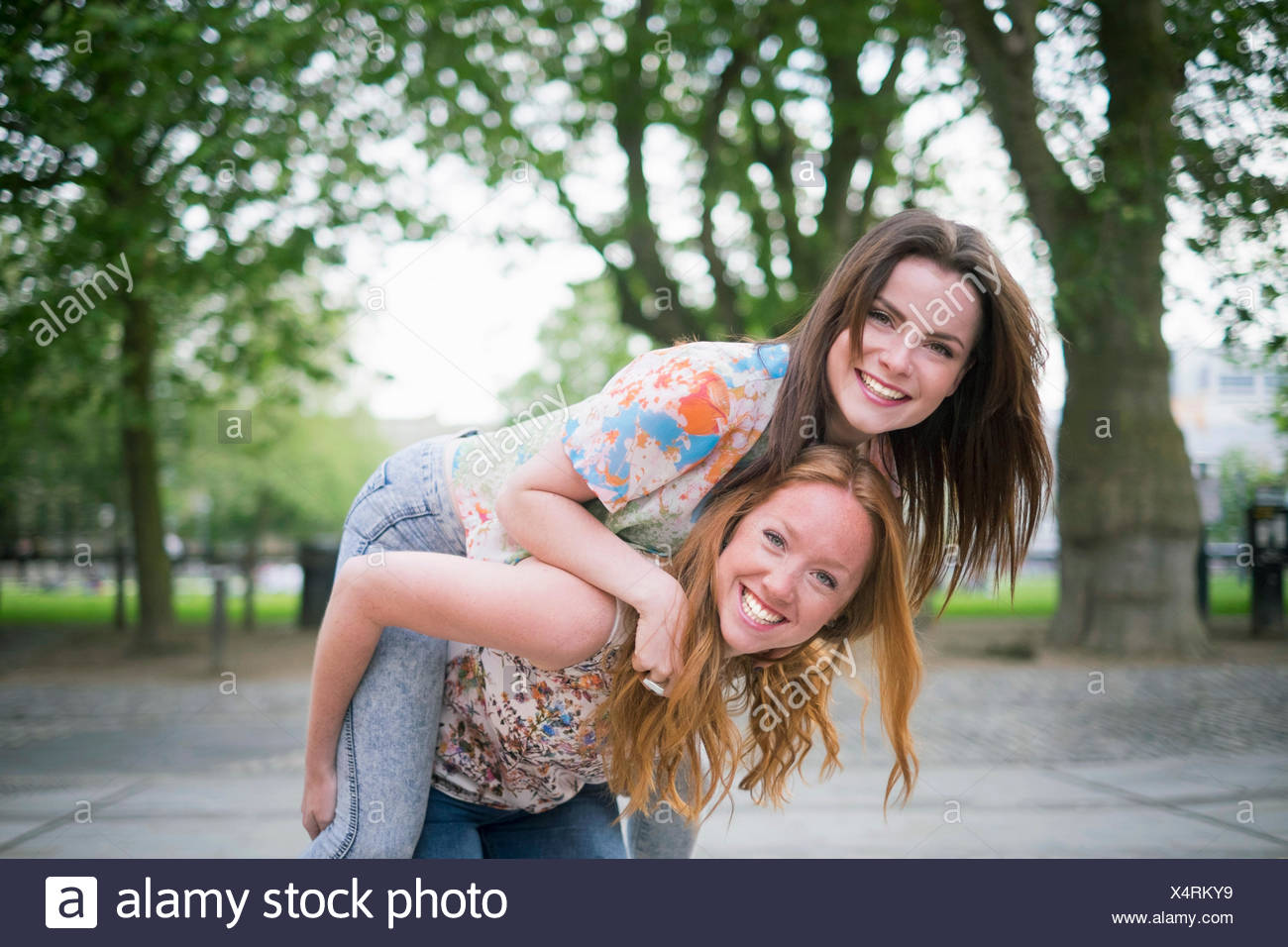 Portrait Of Two Young Female Best Friends Giving Piggy Back In Park Stock Photo Alamy Portrait Of Two Young Female Best Friends Giving Piggy Back In Park Stock Photo Alamy