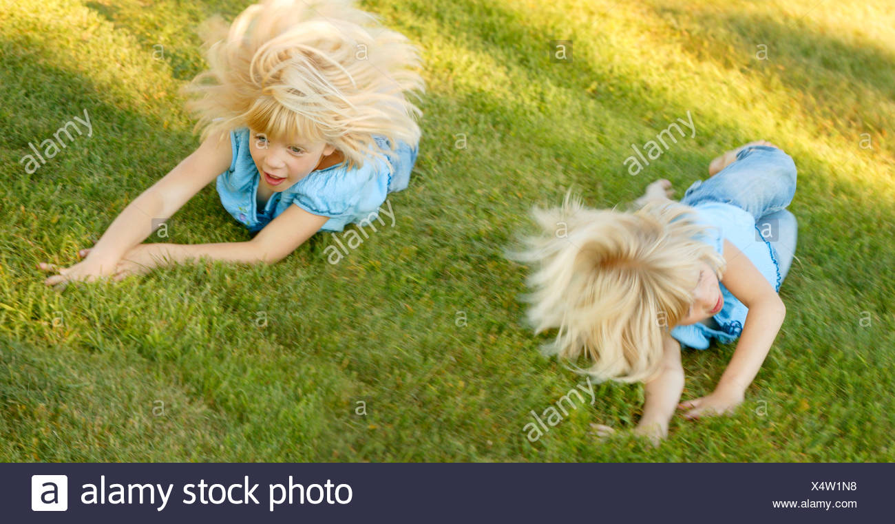 Children Rolling Down Hill High Resolution Stock Photography and Images