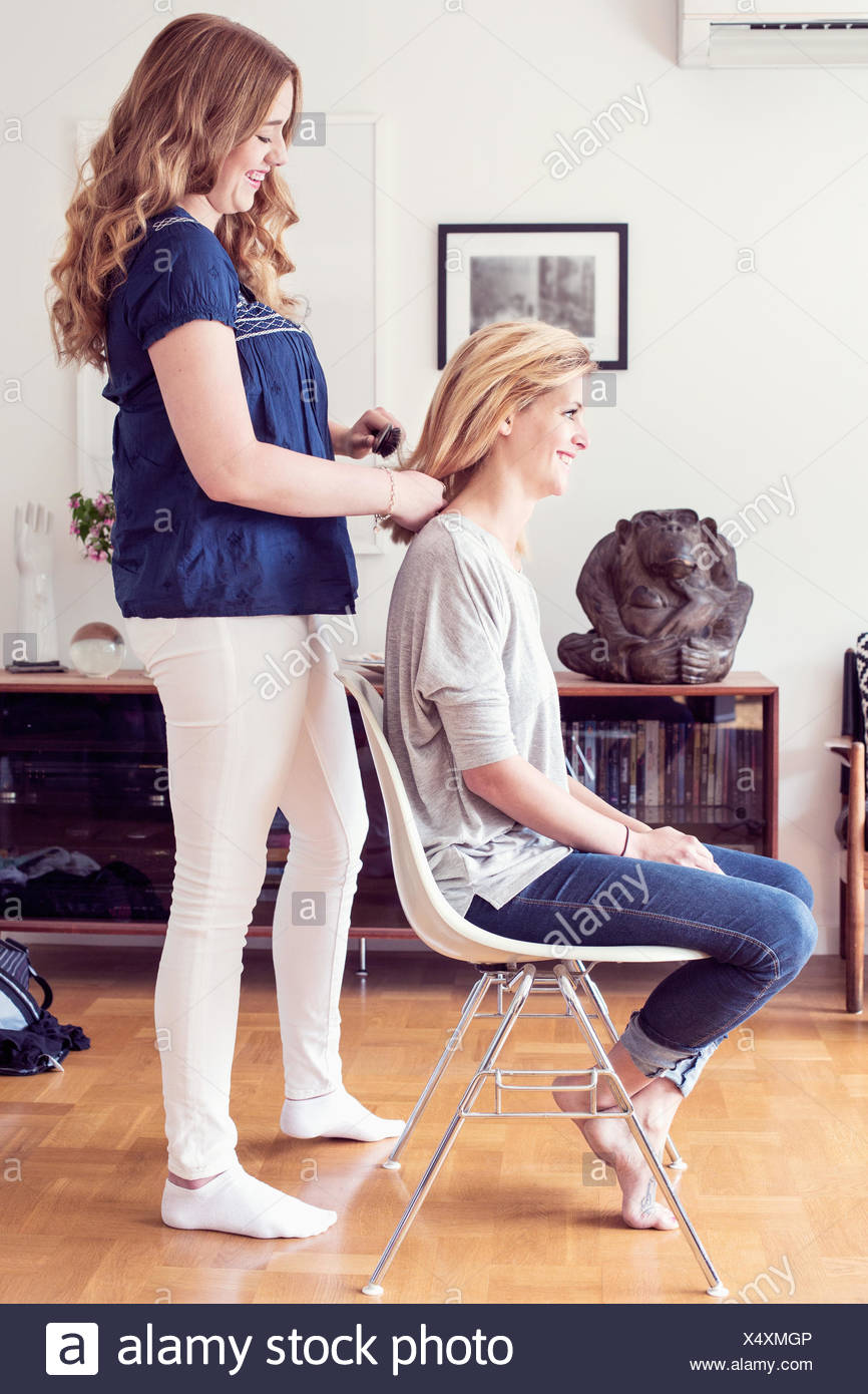 Girl Brushing Her Sisters Hair High Resolution Stock Photography and