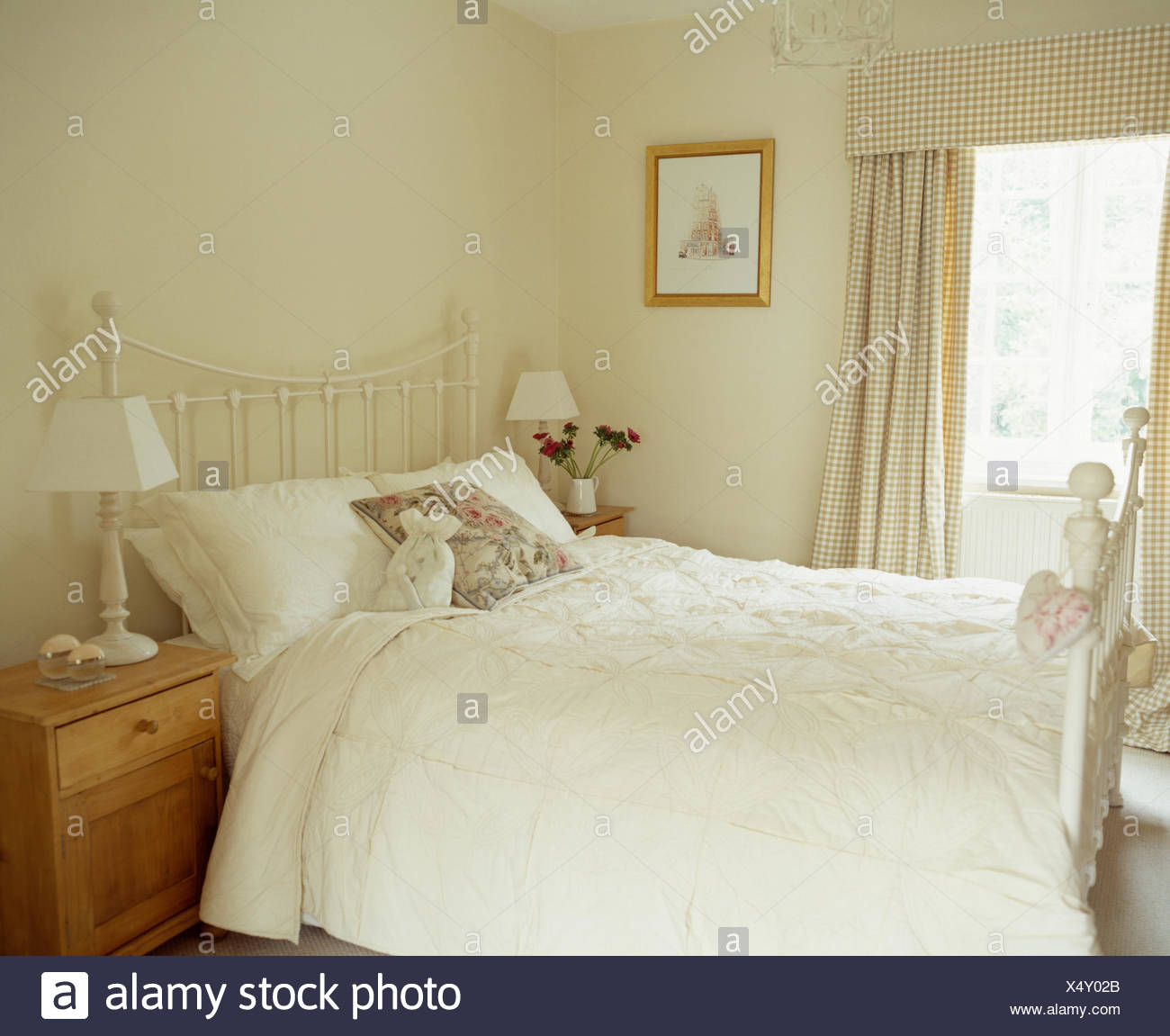 White Quilt On White Painted Brass Bed In Simple Country