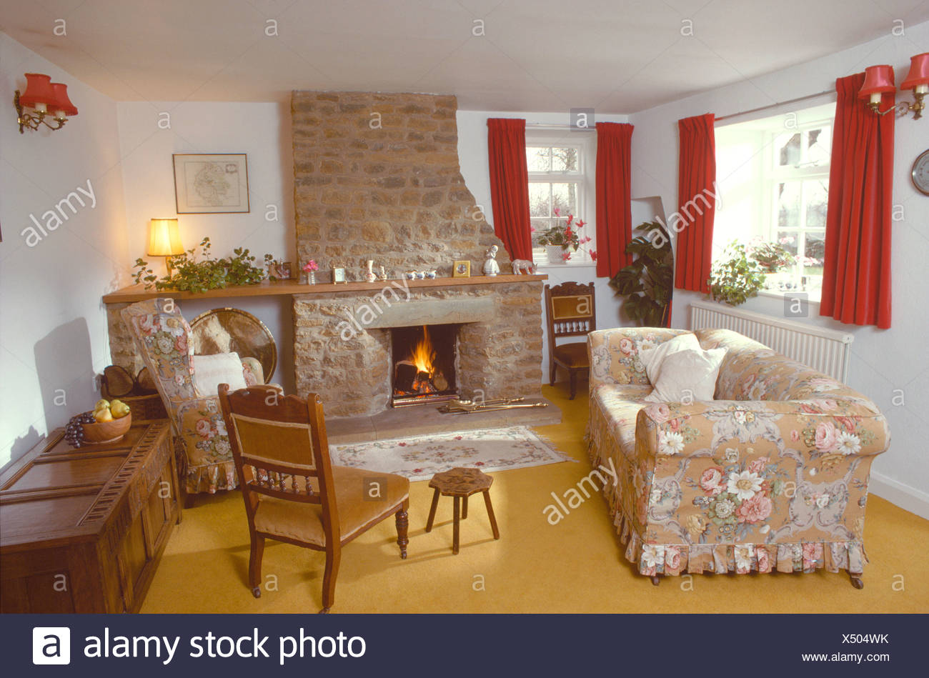 Floral Loose Cover On Sofa In Front Of Stone Fireplace With