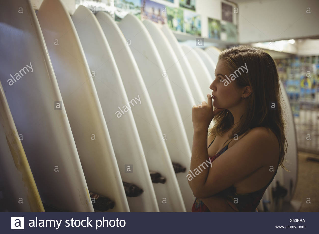 Woman Selecting A Surfboard In Beach Cabin Stock Photo 278454382