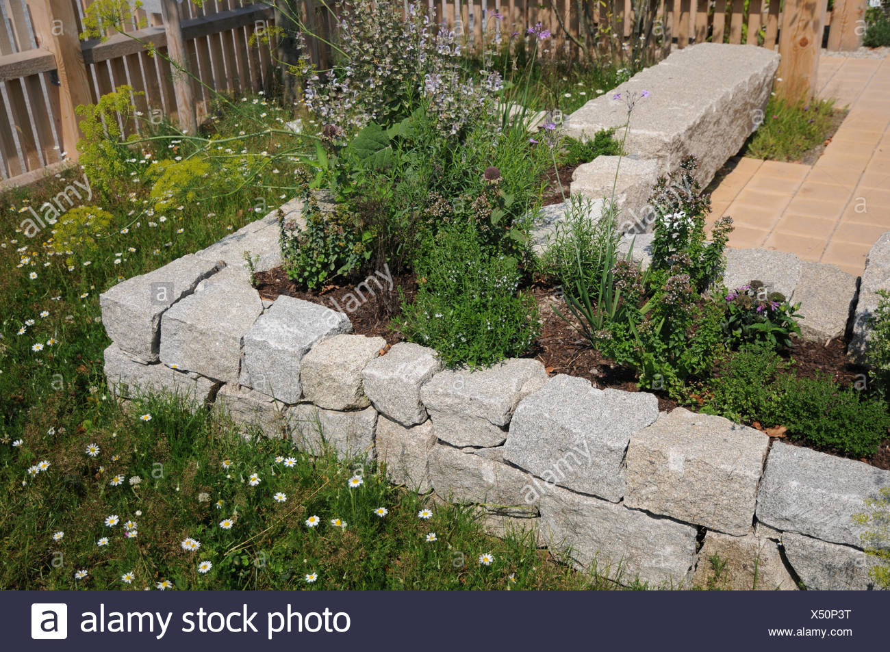 Raised bed made of granite stones Stock Photo