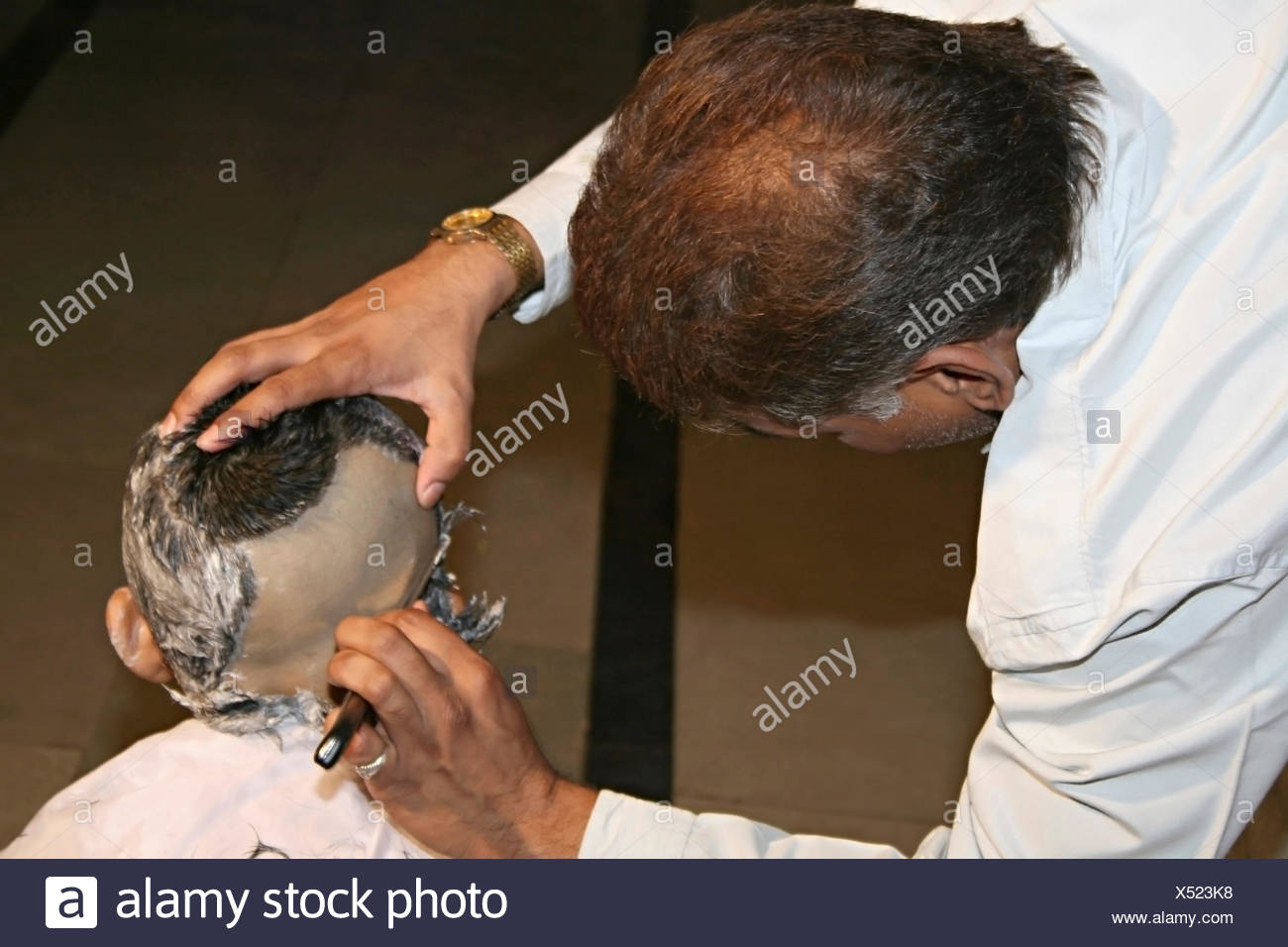 Getting a hair-cut for threading ceremony, a typical Hindu ritual