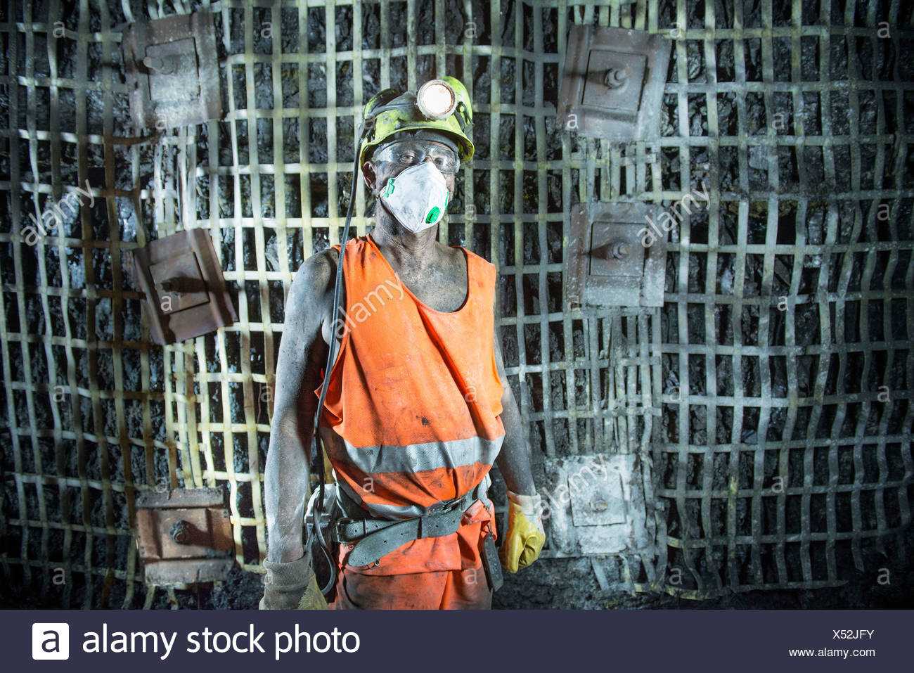 Coal miner standing in mine Stock Photo