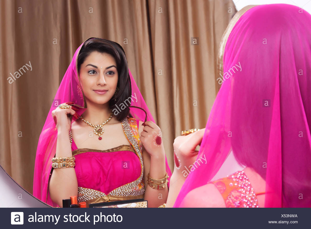 Beautiful woman admiring herself in the mirror Stock Photo ...