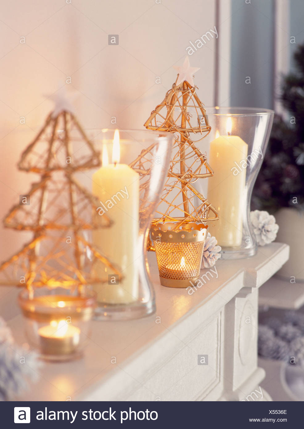Close Up Of Glass Vases With Lighted Candles On Mantelpiece With