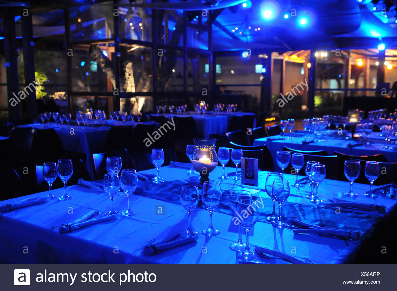 Tables Set For An Evening Wedding Reception Lit With Blue Light