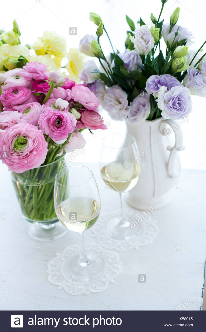 Close Up Of Wine Glasses With Flower Vase Placed On Table Stock