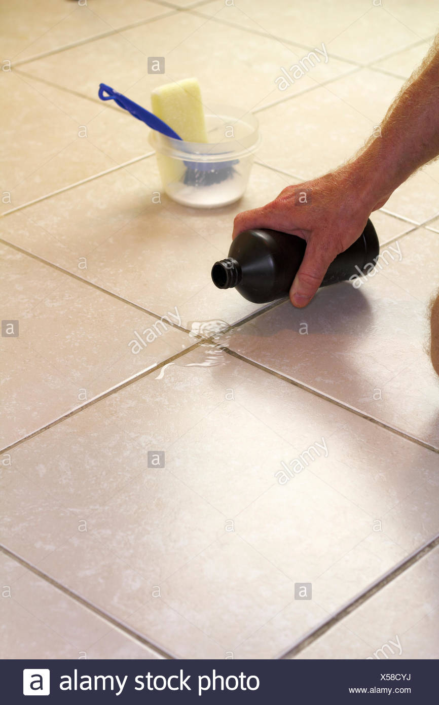 Pouring Hydrogen Peroxide On Floor Grout Stock Photo