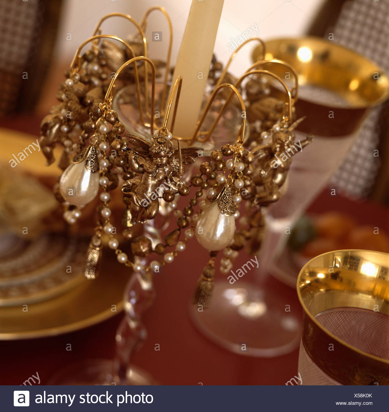Close Up Of Gold Bead Chain And Pearls Decorating Candlestick