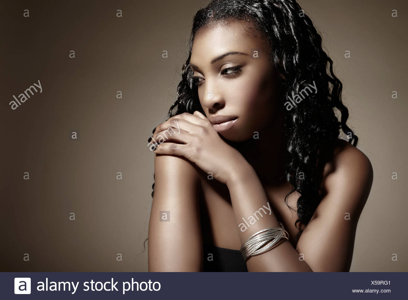 Portrait Of A Young Dark Skinned Woman Wearing Silver Jewellery