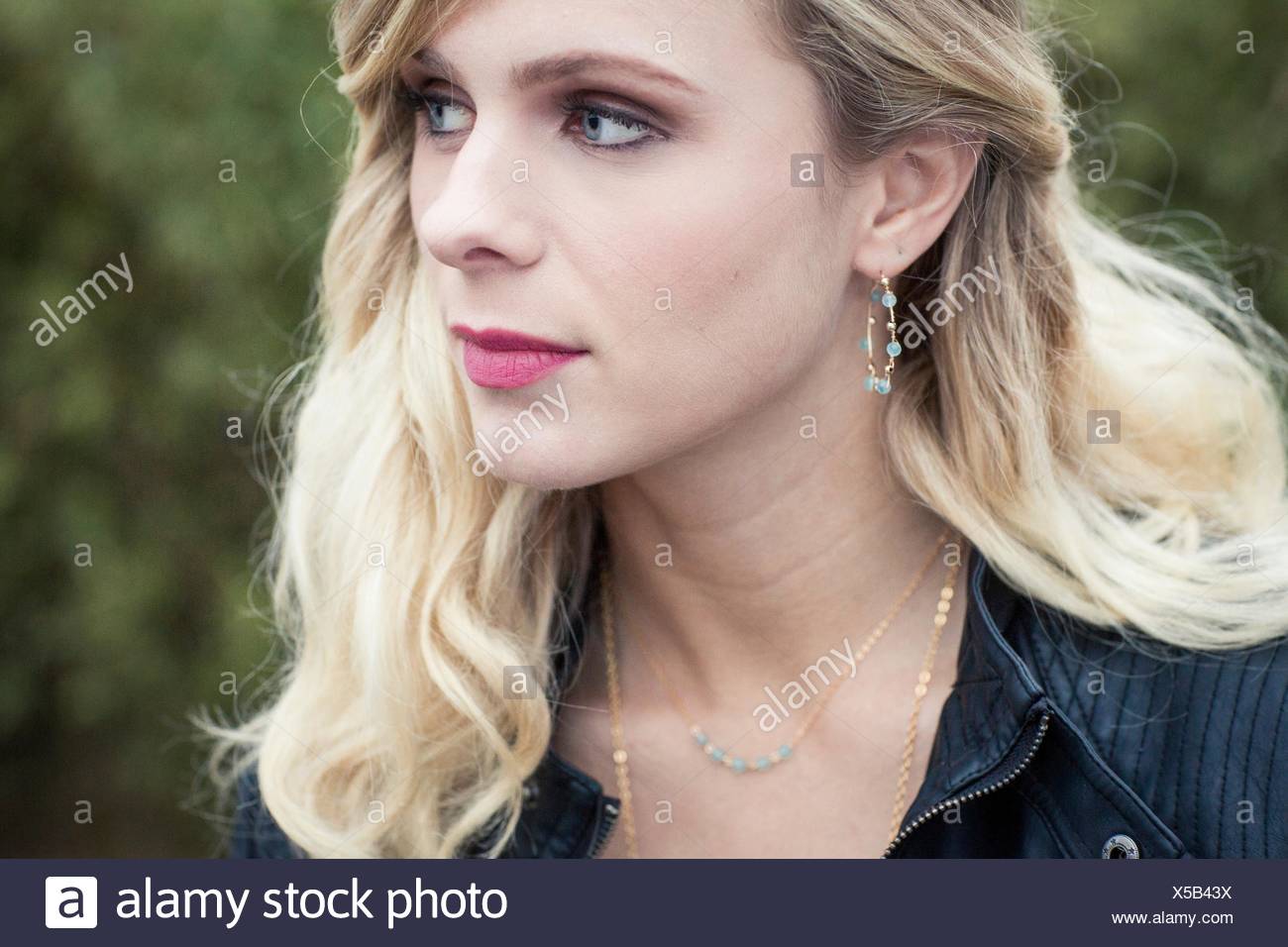 Cropped Portrait Of Young Blonde Haired Woman Wearing Leather Jacket Looking Down Stock Photo Alamy