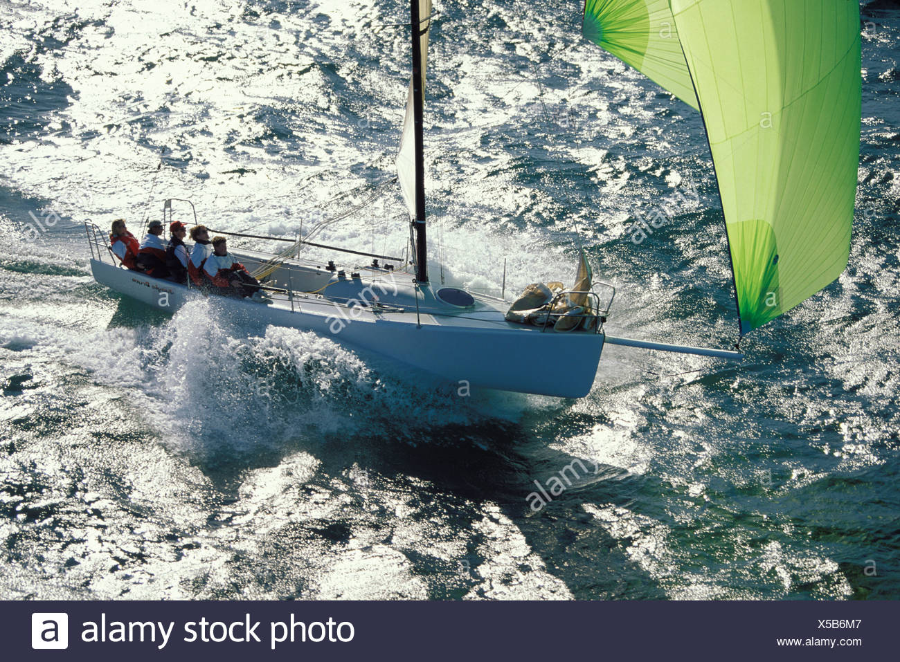 The Crew Of The J90 Jungle Drum Sitting Aft On The Windward Rail As The Boat Takes Off Downwind Under An Asymmetric Spinnaker Stock Photo Alamy