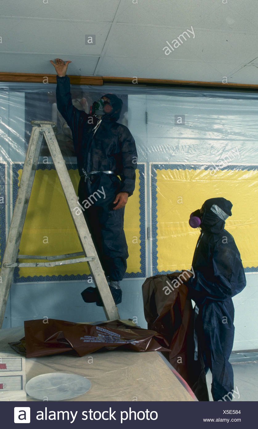 Workers Remove Abestos Ceiling Tile In Virginia School Stock Photo