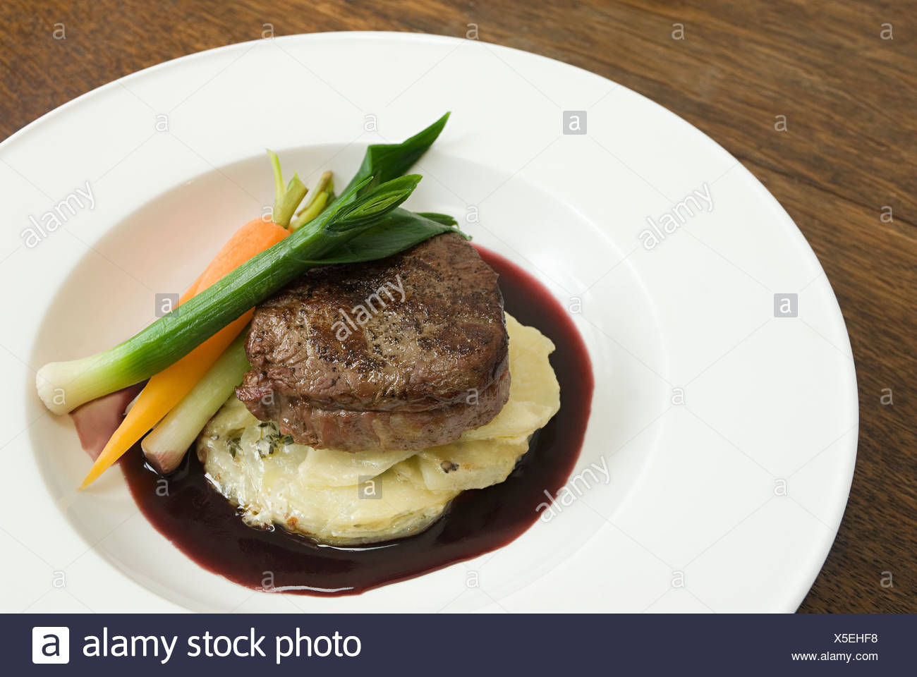 Beef With Dauphinoise Potatoes And Vegetables Stock Photo Alamy