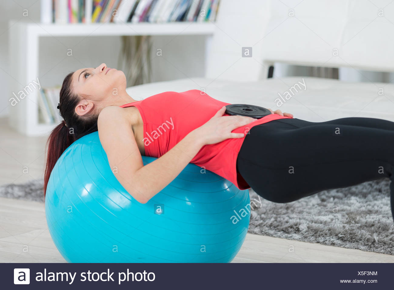 Fitness Girl Doing Crunches Lying On The Floor At Home Stock Photo