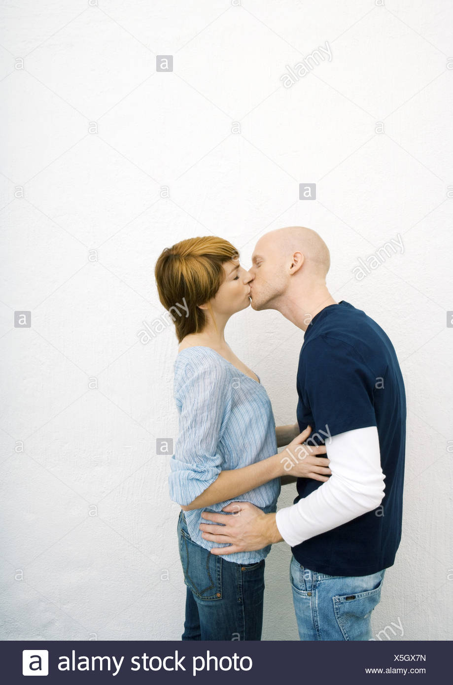 Young Couple Kissing Hands On Each Others Waists Stock Image Young Couple Kissing Hands On Each Others Waists Stock Image