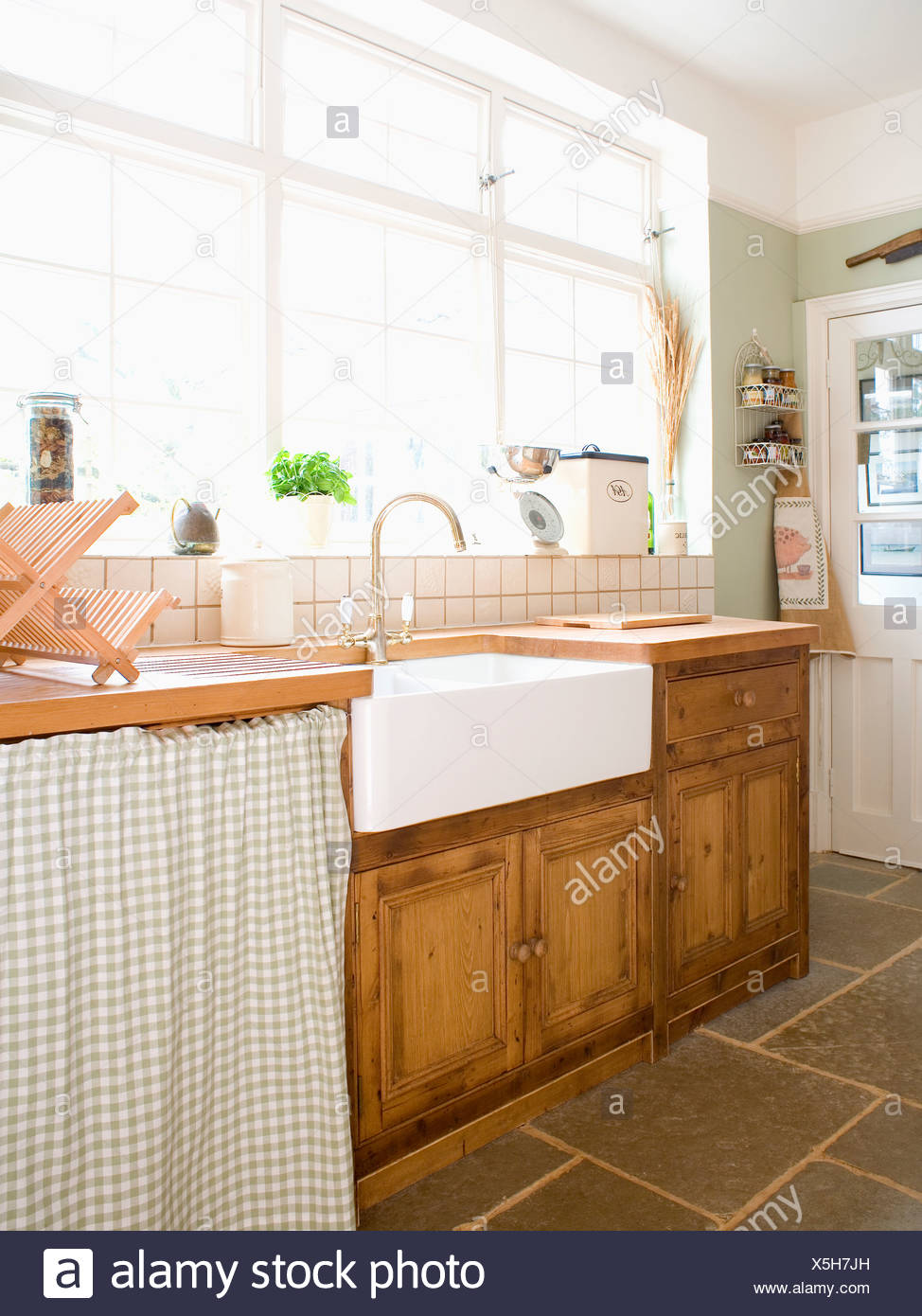 Belfast Sink In Fitted Pine Cupboard Below Window In Country