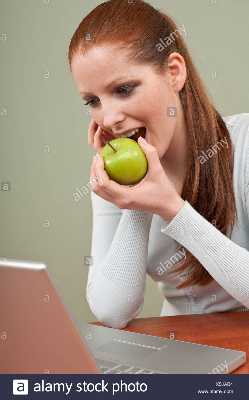 Long Red Hair Woman Biting Apple At Office Stock Photo 278842456