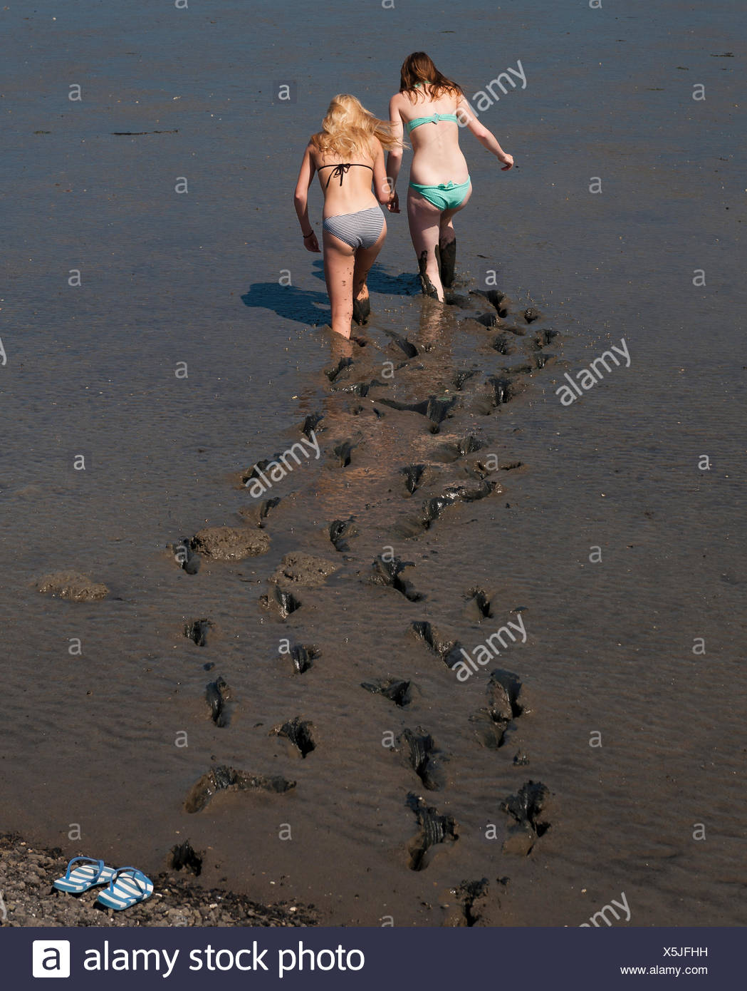 girls walking in mud