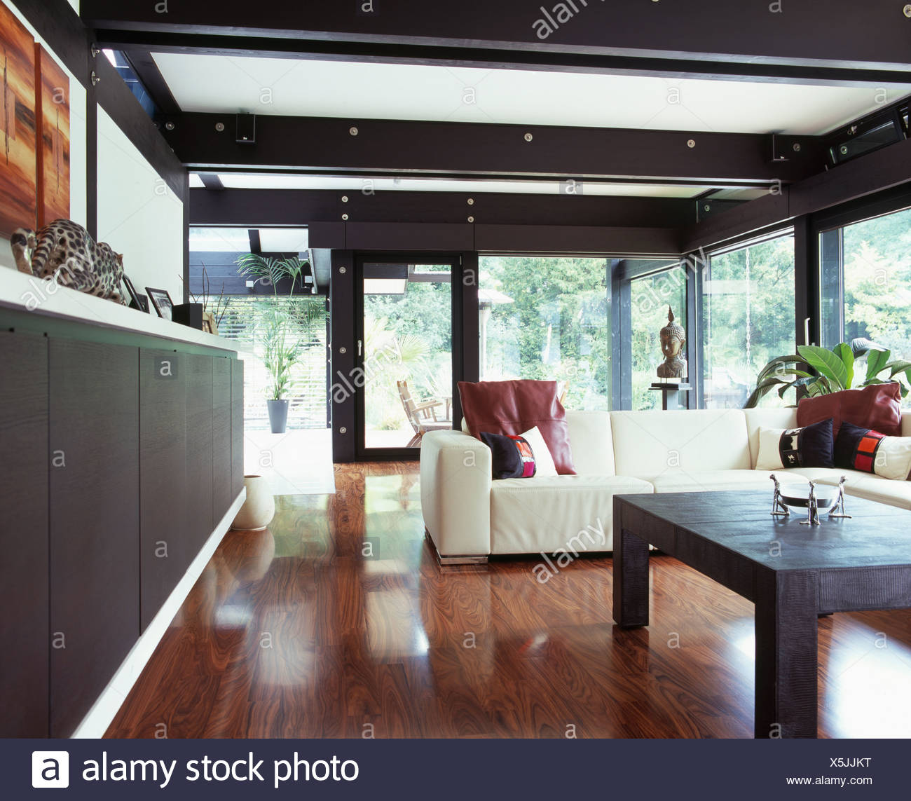 Polished Wooden Flooring In Large Modern Living Room With White