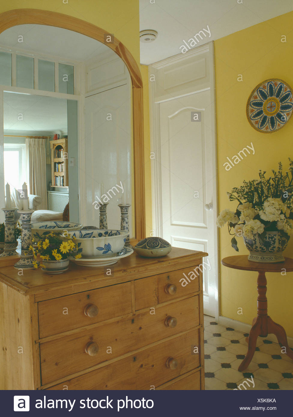Large Pine Mirror Above Pine Chest Of Drawers In Small Yellow Hall
