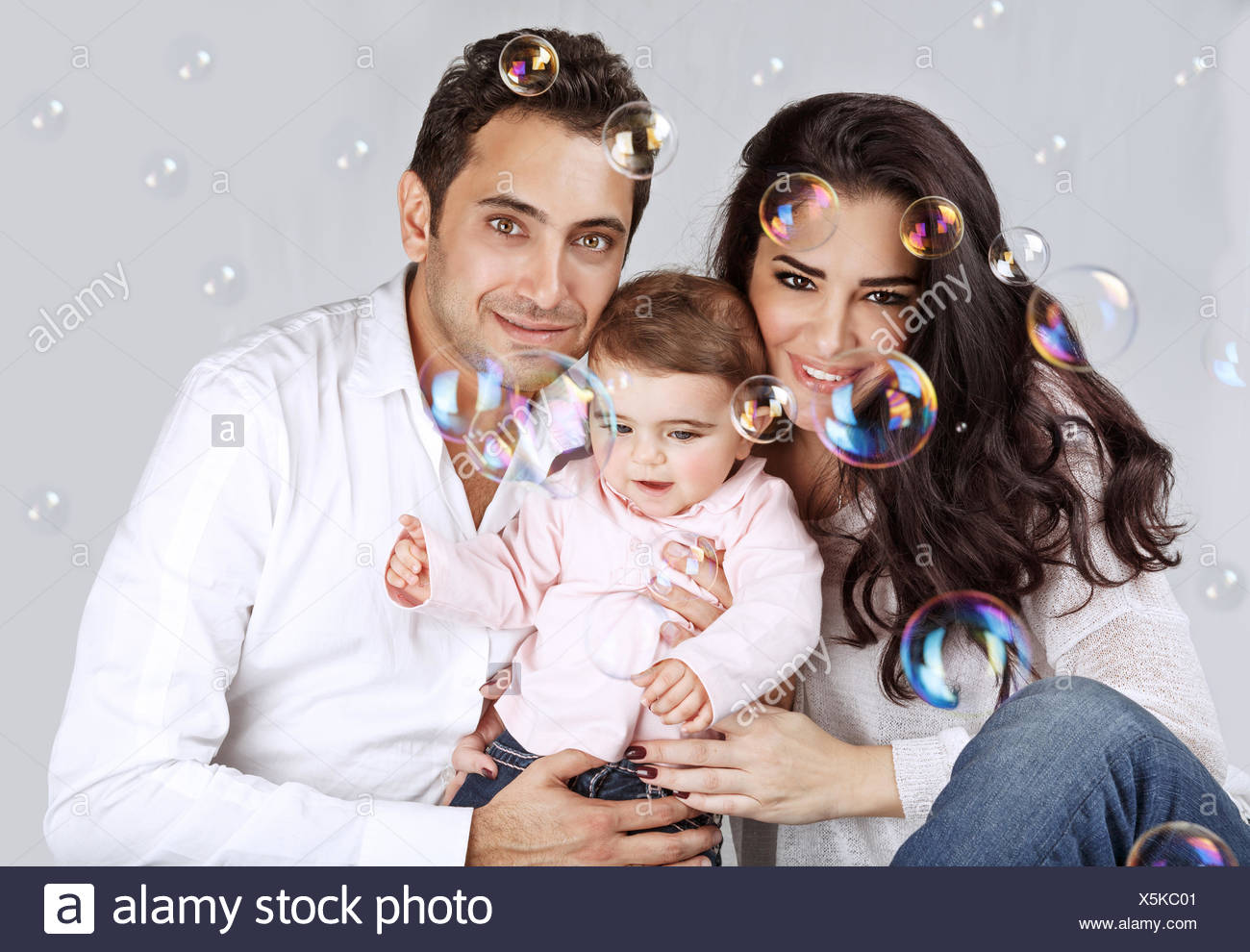 Portrait Of Cute Arabic Baby Girl With Mother And Father Playing