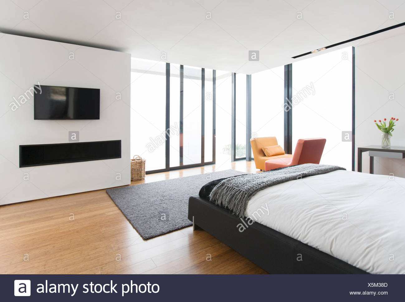Bed And Sliding Glass Doors In Modern Bedroom Stock Photo