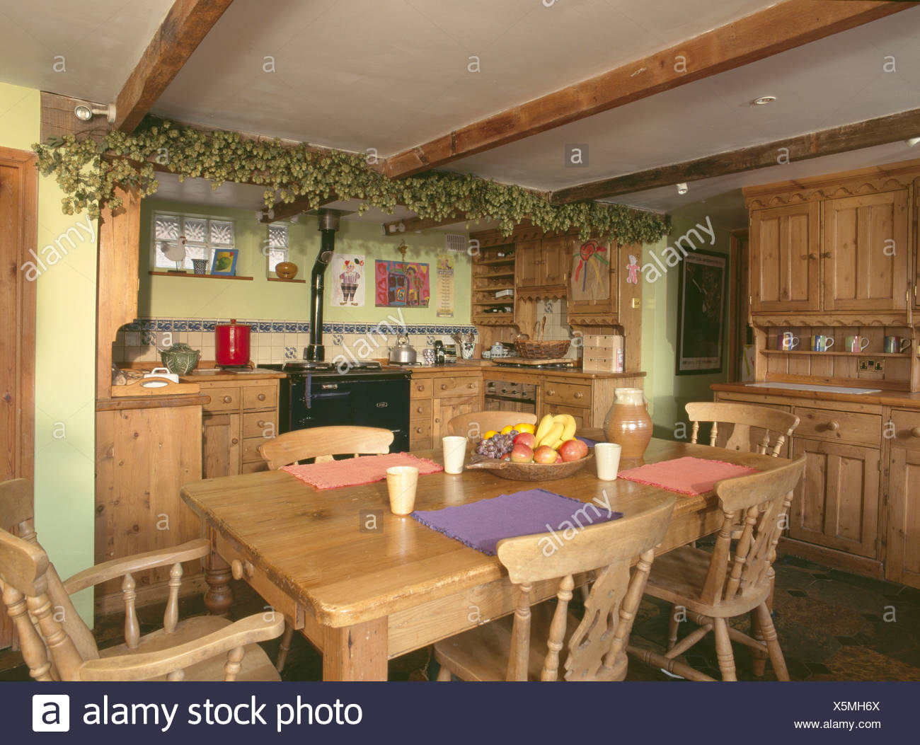Dried Hop Garland On Ceiling Beams On Fitted Wooden Kitchen