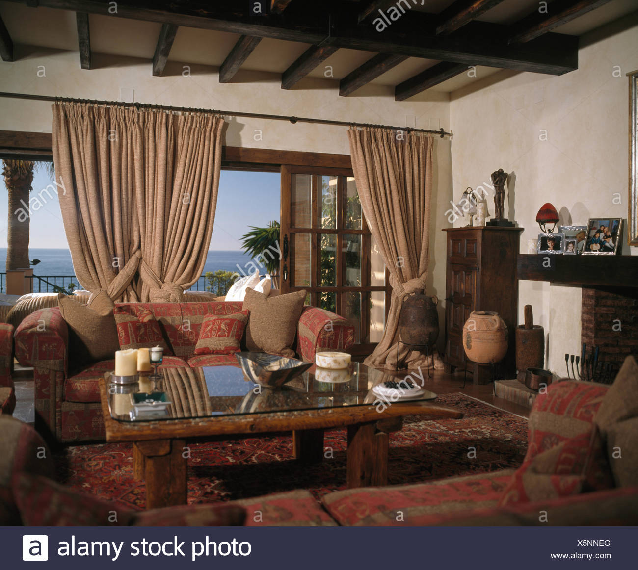 Living Room In Spanish Villa With Heavy Beige Drapes On Patio