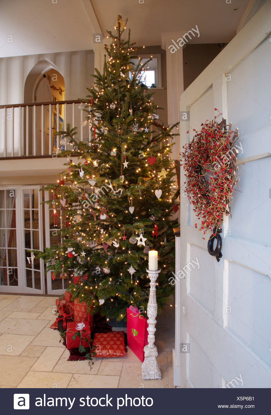Wreath On Open Front Door With View Of Tall Christmas Tree