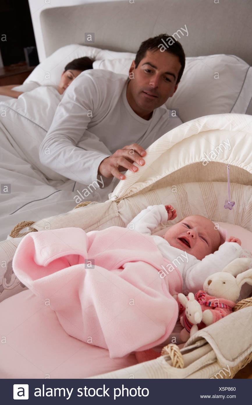 Newborn Baby Crying In Cot In Parents Bedroom Stock Photo Alamy