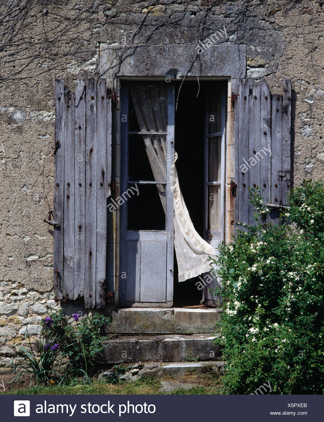 Dilapidated Wooden Shutters On French Doors Of Country House In