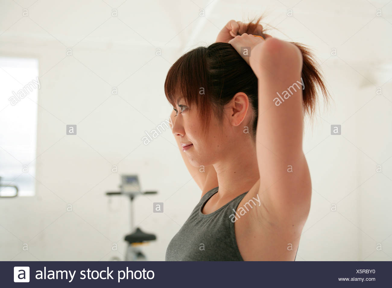 Young Woman Tying Hair Back In Gym Stock Photo 278953444 Alamy