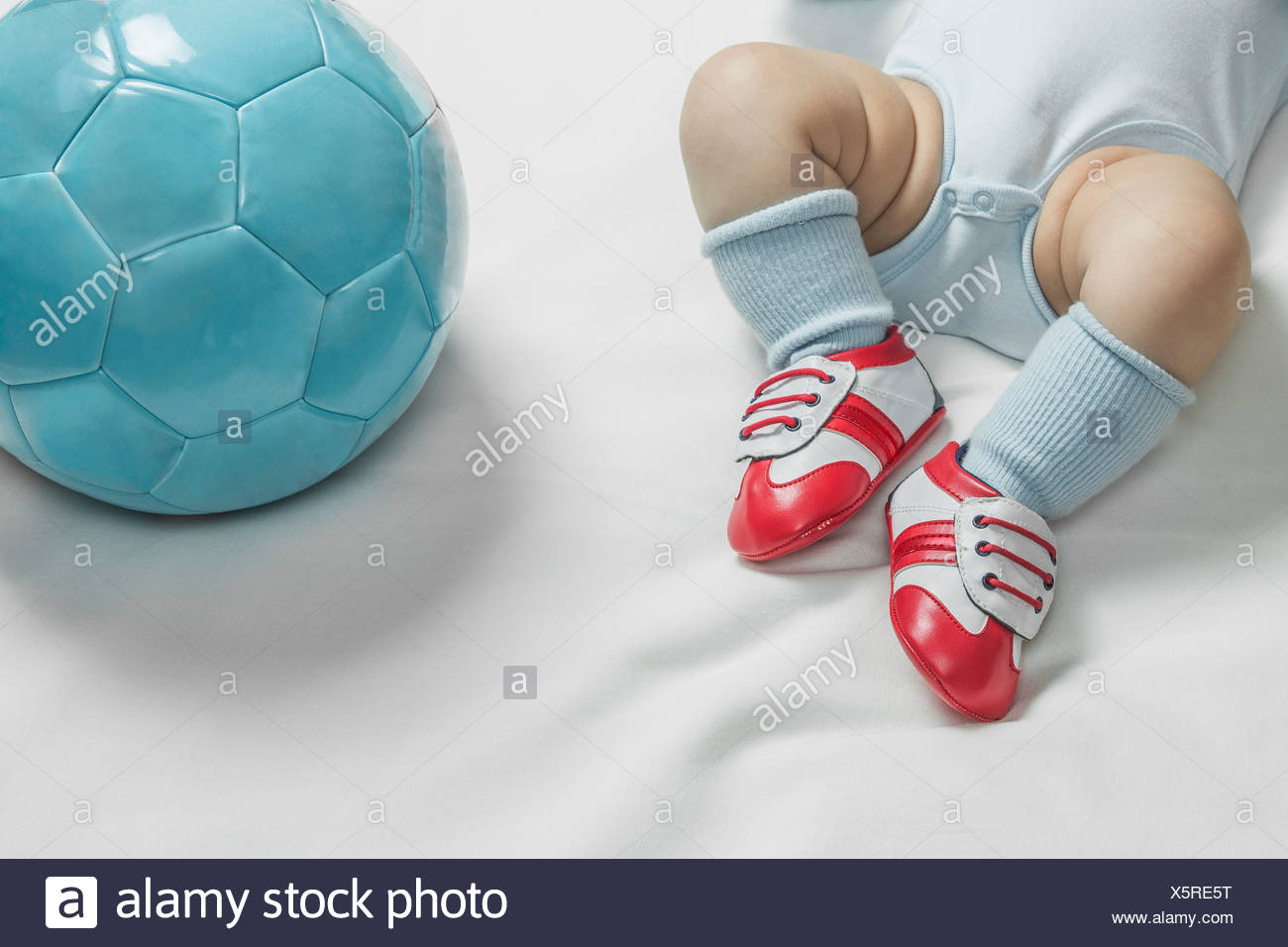 A baby boy wearing baby soccer shoes 