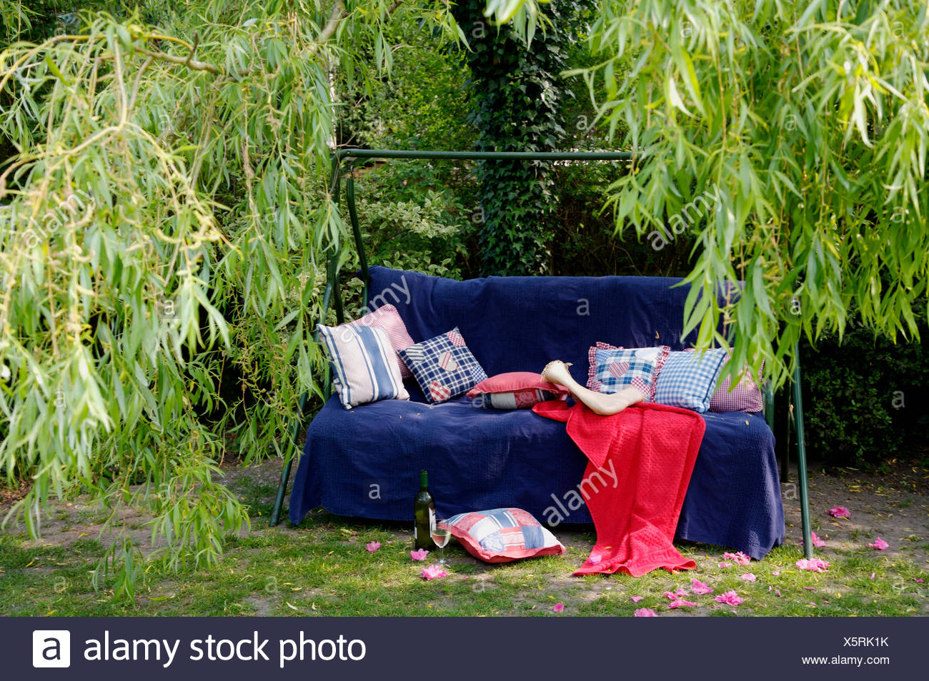 Blue Checked And Striped Cushions And Red And Blue Throws On Metal