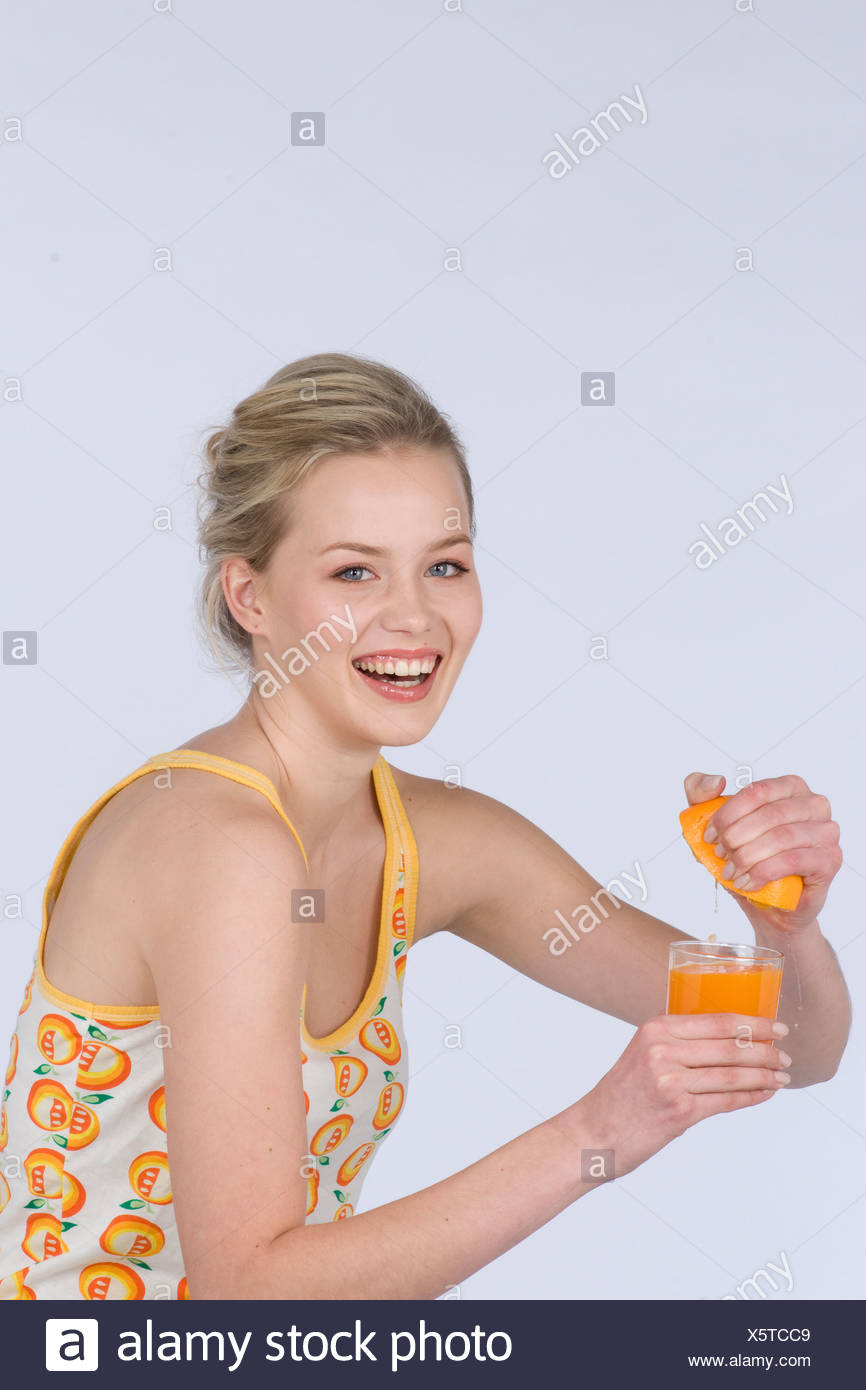 Female Dark Blonde Hair Tied Back Wearing A White Top An Orange