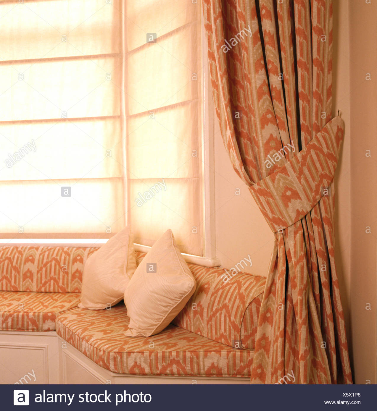 Plain Blinds And Patterned Curtains On Window Above Fitted Window