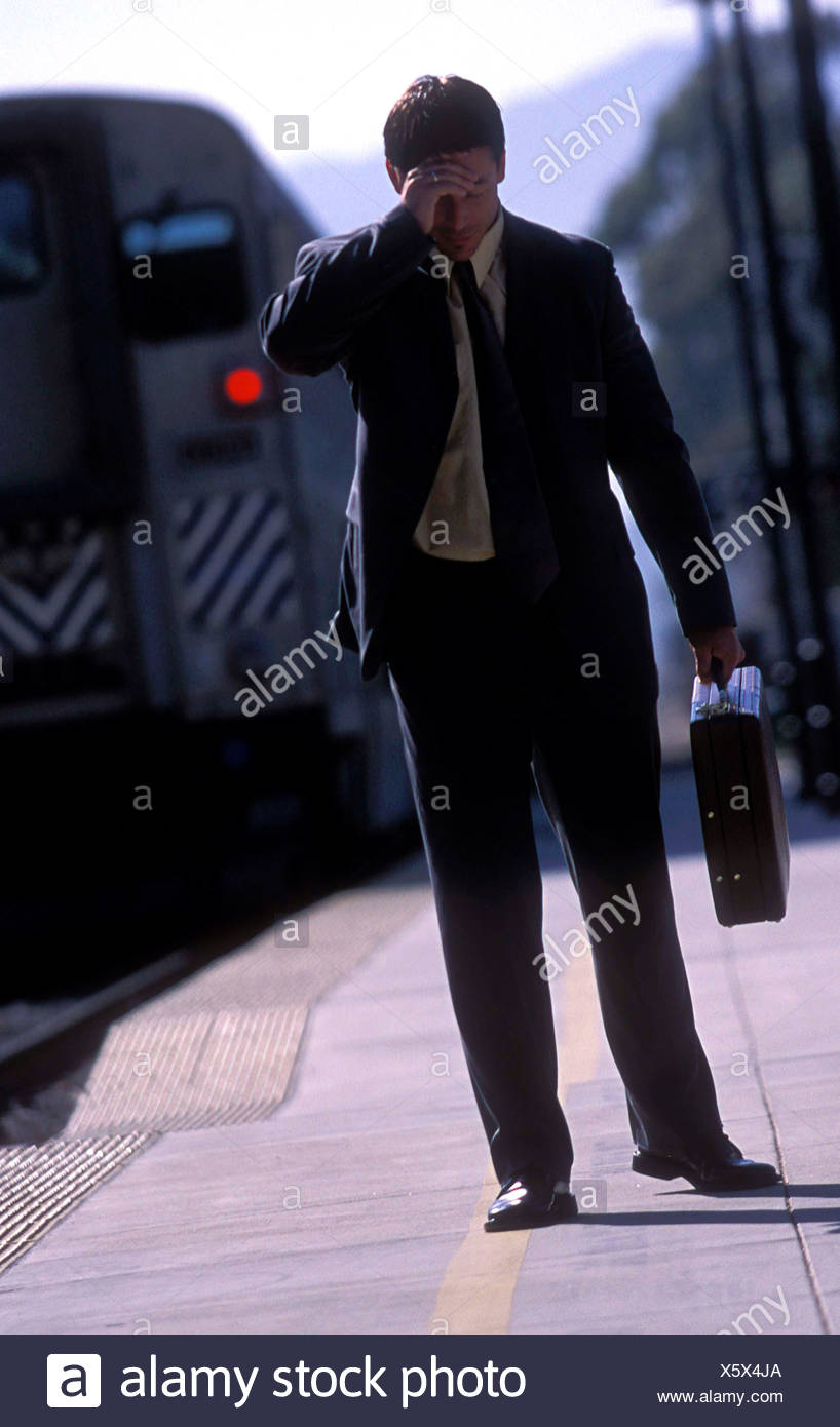 Male Short Brown Hair Wearing Grey Suit And Tie And Yellow