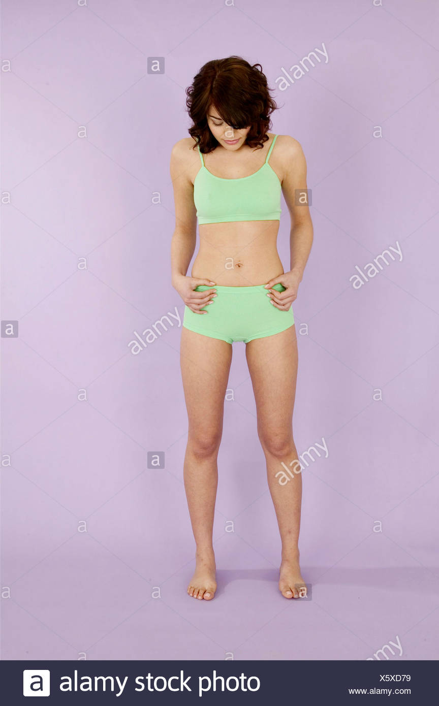 Female Curly Brunette Hair Wearing Green Bra Top And