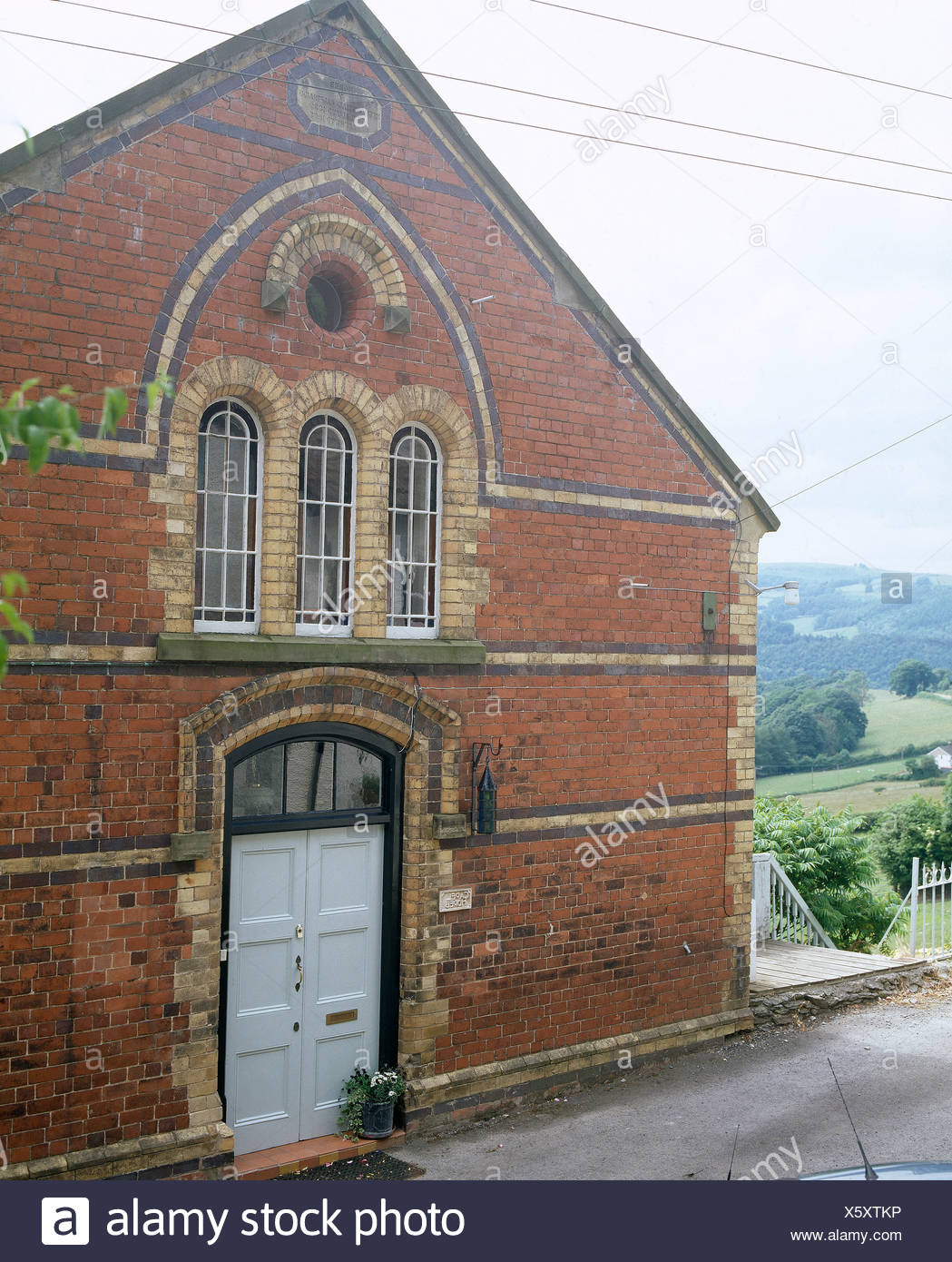 Exterior Of A Converted Victorian Chapel With Arched Windows