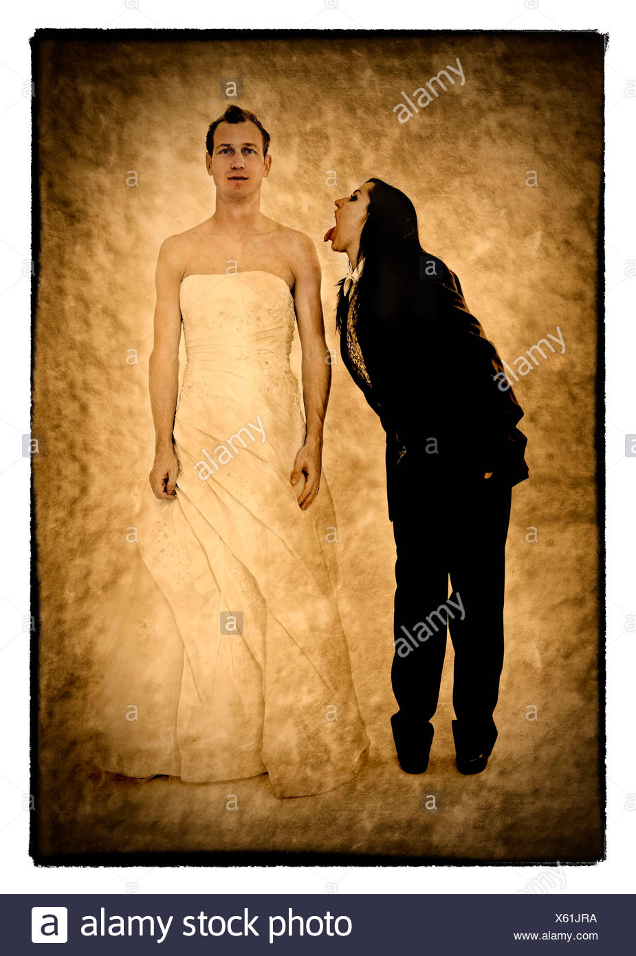 Bride Wearing A Suit Poking Her Tongue Out At The Groom Wearing A