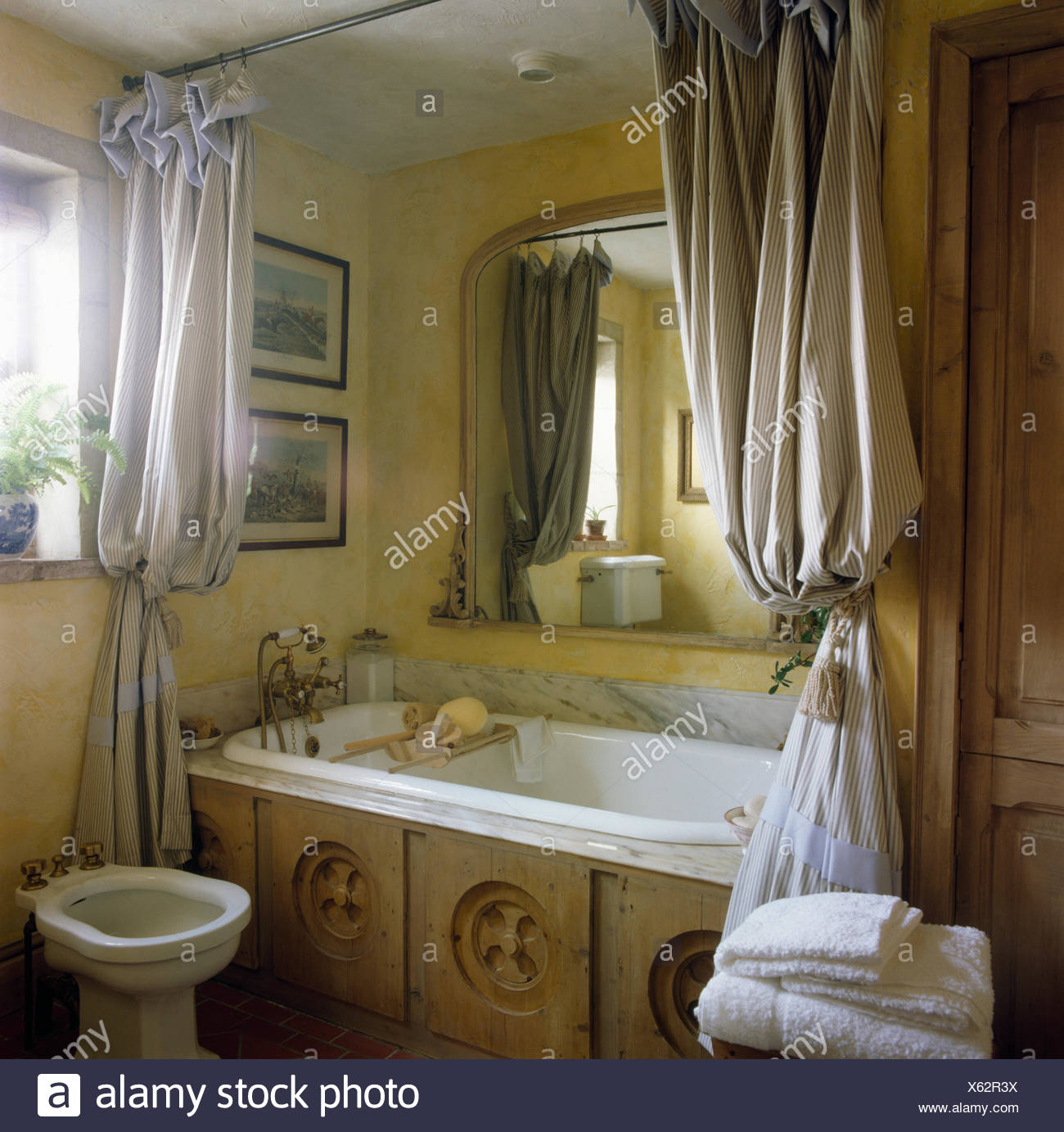 Striped Shower Curtains On Bath With Reclaimed Carved Wood Panel